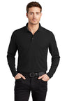 Male model wearing OGIO Caliber2.0 Long Sleeve OG105 polo in black, 5oz poly pique with stay-cool wicking, 3-button.