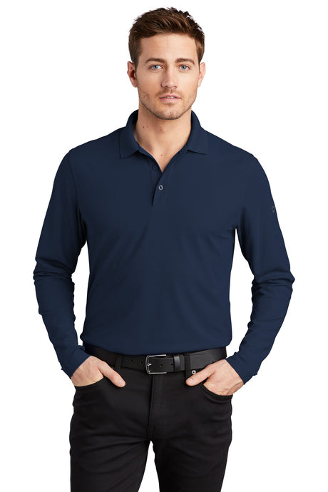 Male model in navy OGIO Caliber2.0 Long Sleeve OG105 polo with flat knit collar and 3-button placket.